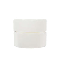 A small white plastic travel jar perfect for taking Dr. Bailey Skin Care with you where ever you go.