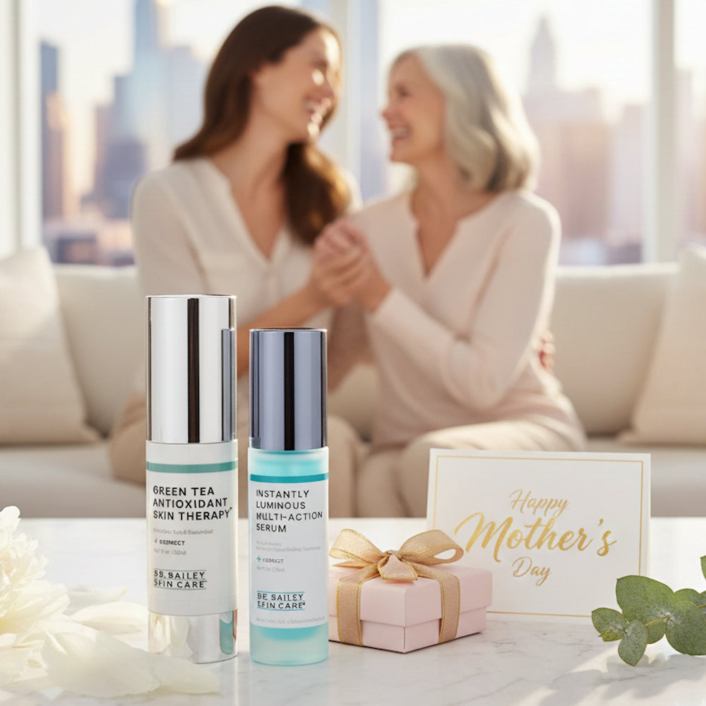 Two skincare products on a table with a 'Happy Mother's Day' card and gift box, blurred background of two women embracing.